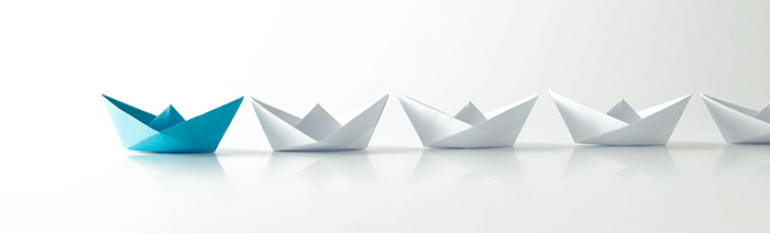 a decorative image of some paper boats representing the leads that we sell
